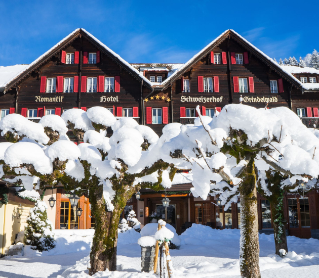 Romantik Hotel Schweizerhof in winter with snow outside