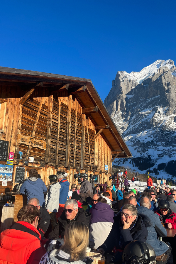people eating out on a sunny day at one of Grindelwald's mountain huts