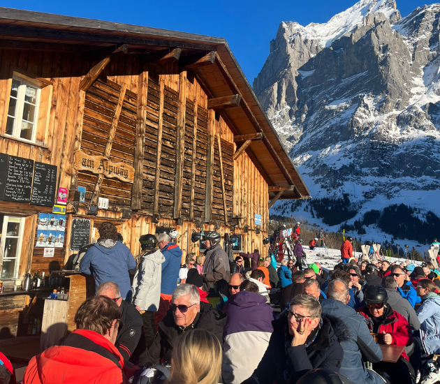 People drinking on a sunny day at Grindewald in one of the mid-mountain huts