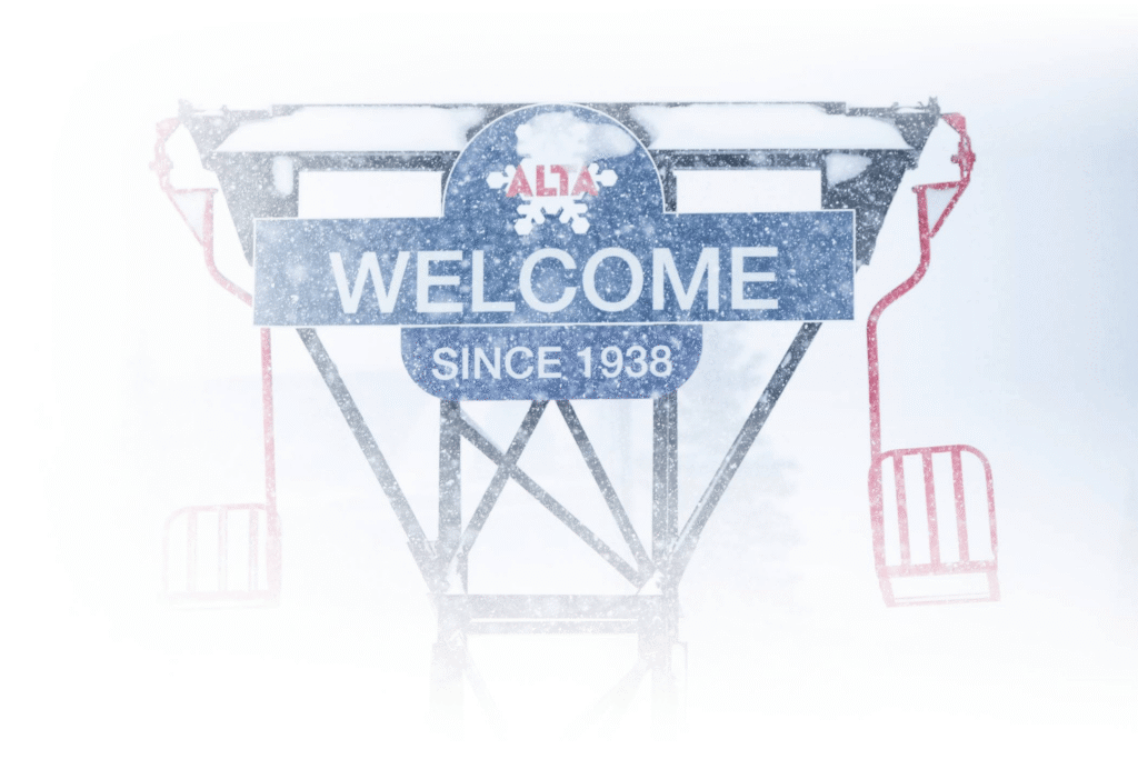 the welcome sign of Alta Ski Area covered in snow