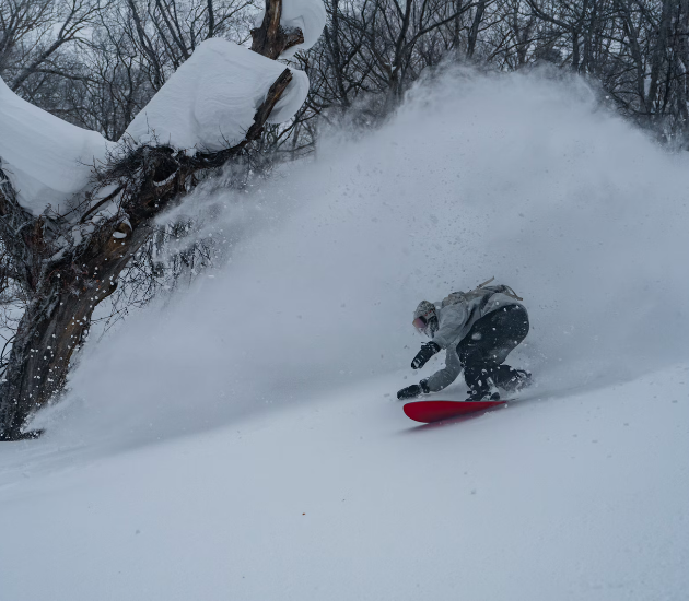 snowboarder carving on deep snow